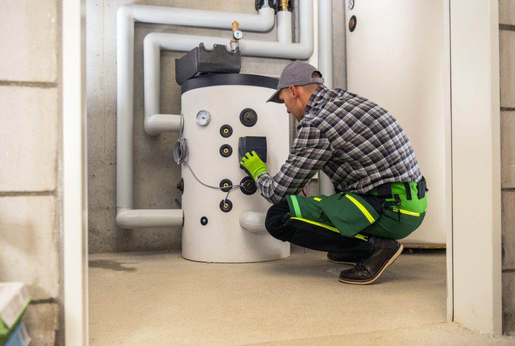 HVAC Technician Finishing Installation of Gas Heating Boiler